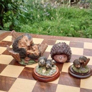 Collection of four Hedgehog Figurines, Three Pottery and One Candle.