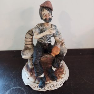 Capodimonte Figurine. Man On Bench. Good Condition.